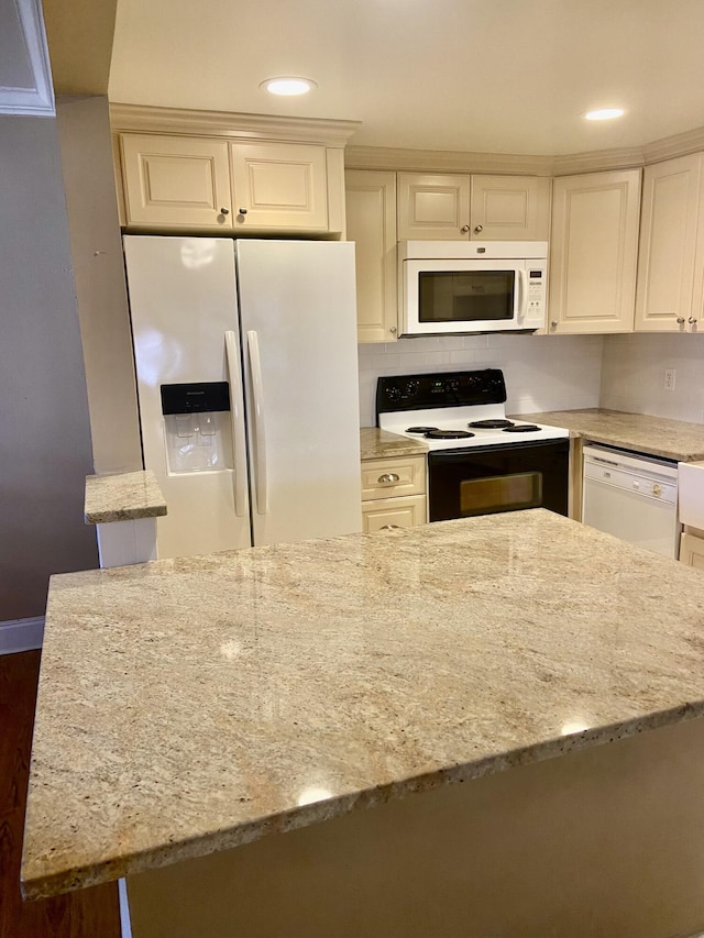 294 Brittany Unit G, Delray Beach, FL 33446 - kitchen with white appliances, recessed lighting, light stone countertops, white cabinetry, and dark wood-style floors