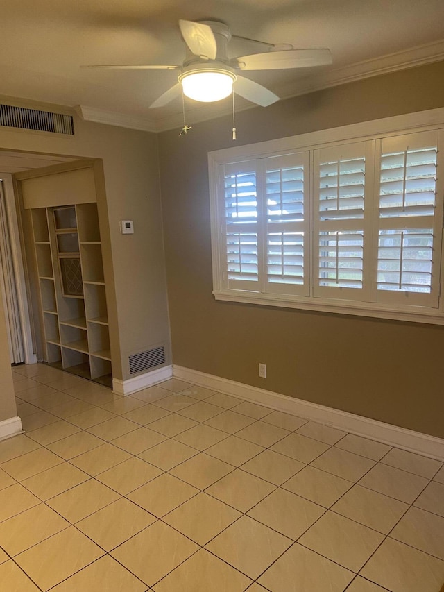 294 Brittany Unit G, Delray Beach, FL 33446 - spare room with ornamental molding, baseboards, light tile patterned flooring, and ceiling fan