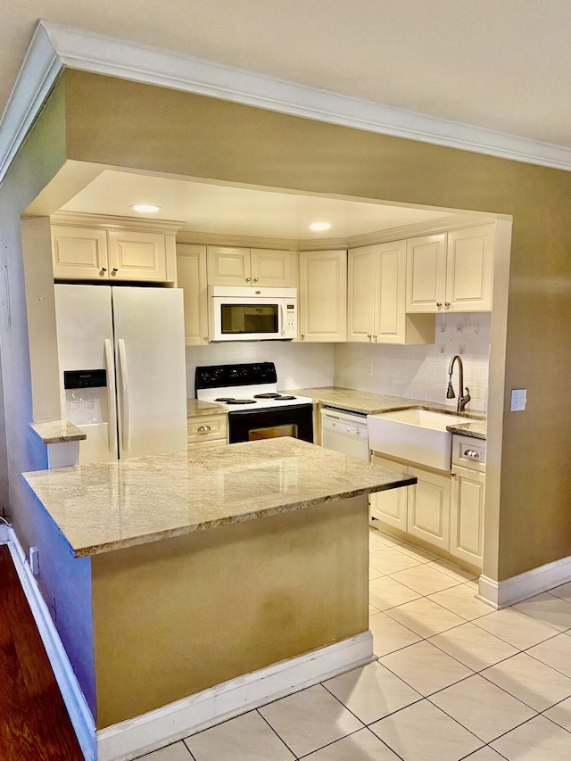 294 Brittany Unit G, Delray Beach, FL 33446 - kitchen featuring white appliances, crown molding, light stone countertops, light tile patterned floors, and backsplash