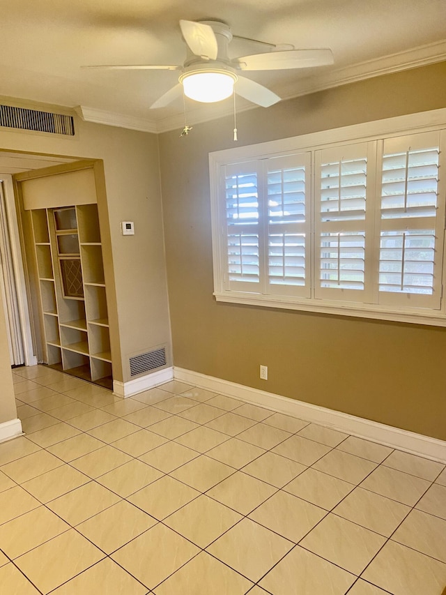 294 Brittany Unit G, Delray Beach, FL 33446 - unfurnished room featuring crown molding, a ceiling fan, and light tile patterned floors
