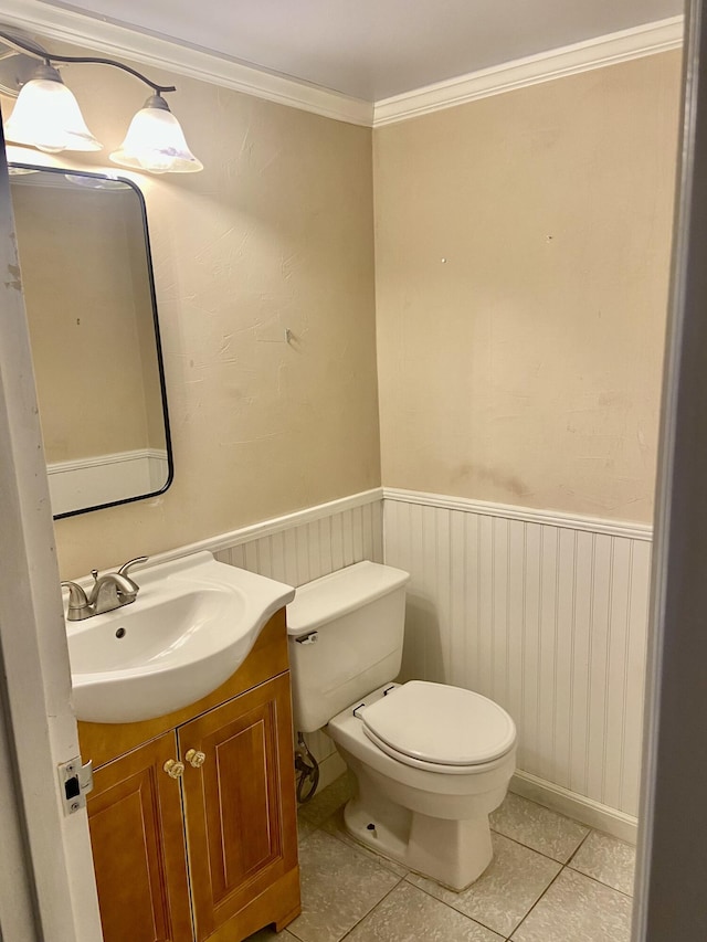 294 Brittany Unit G, Delray Beach, FL 33446 - bathroom featuring vanity, a wainscoted wall, tile patterned floors, and ornamental molding