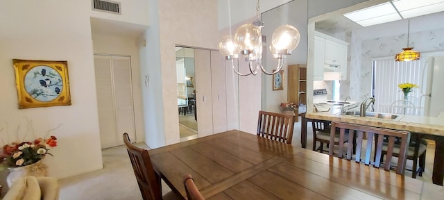3710 English Rd Unit A, Lake Worth, FL 33467 - dining area featuring a chandelier, a towering ceiling, and carpet flooring