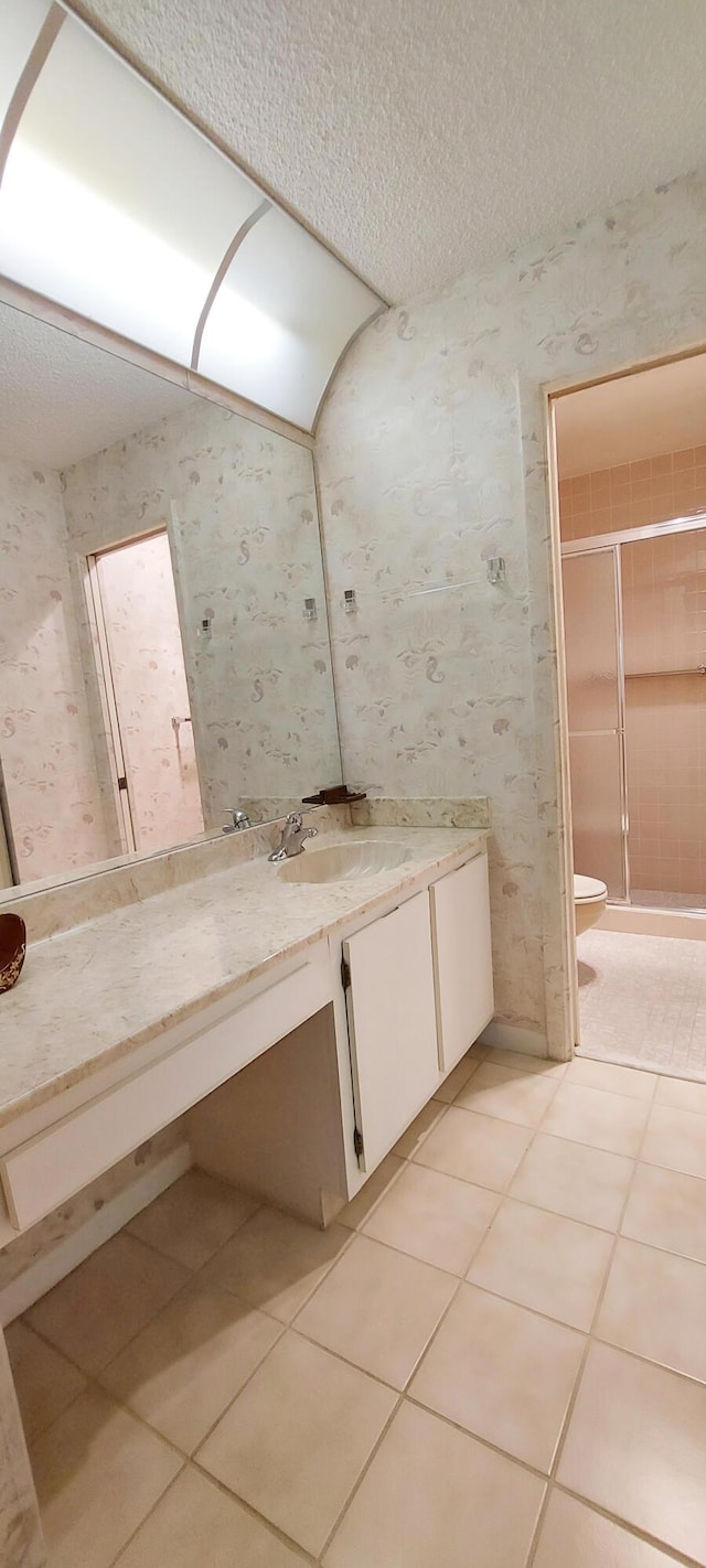 3710 English Rd Unit A, Lake Worth, FL 33467 - bathroom featuring vanity, tile patterned floors, a stall shower, a textured ceiling, and wallpapered walls