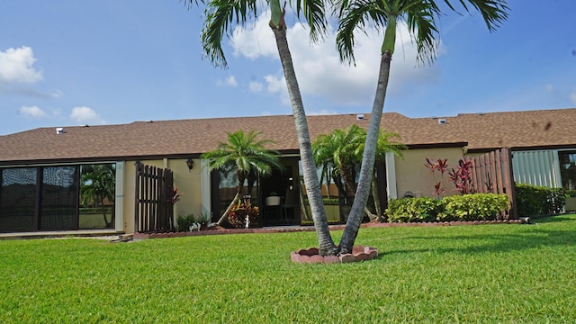 804 Sky Pine Way Unit C, Greenacres, FL 33415 - back of property featuring stucco siding, a lawn, and a shingled roof