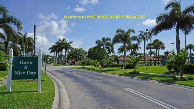 804 Sky Pine Way Unit C, Greenacres, FL 33415 - view of asphalt street featuring curbs, traffic signs, and street lights
