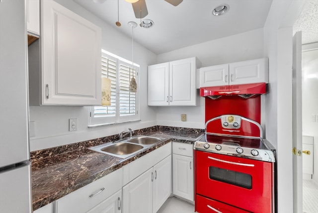 117 Lake Dora Dr, West Palm Beach, FL 33411 - kitchen featuring freestanding refrigerator, a sink, stove, under cabinet range hood, and white cabinets