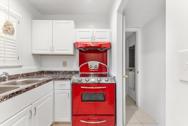 117 Lake Dora Dr, West Palm Beach, FL 33411 - kitchen featuring white cabinets, dark countertops, light tile patterned flooring, and a sink