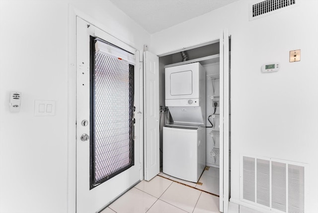 117 Lake Dora Dr, West Palm Beach, FL 33411 - laundry room with stacked washer and clothes dryer and light tile patterned floors