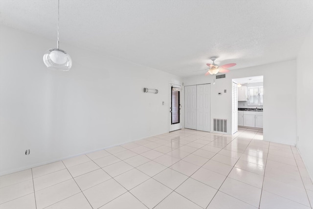 117 Lake Dora Dr, West Palm Beach, FL 33411 - empty room with ceiling fan, light tile patterned floors, and a textured ceiling