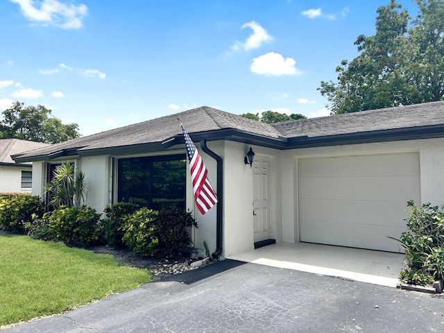 4940 Hawkwood Way Unit A, Boynton Beach, FL 33436 - ranch-style home featuring stucco siding, a garage, driveway, and a front yard