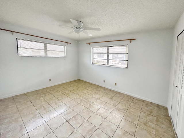 4940 Hawkwood Way Unit A, Boynton Beach, FL 33436 - unfurnished bedroom featuring a textured ceiling, light tile patterned floors, a closet, and ceiling fan