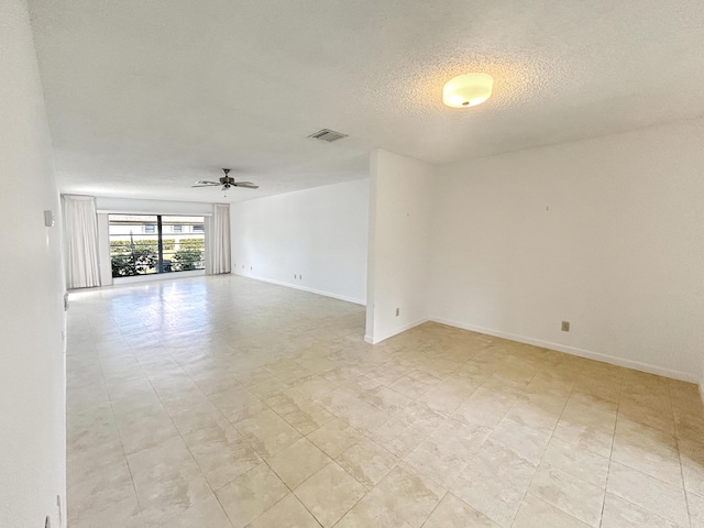 4940 Hawkwood Way Unit A, Boynton Beach, FL 33436 - unfurnished room with ceiling fan, a textured ceiling, and baseboards