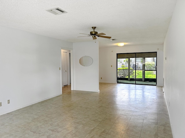 4940 Hawkwood Way Unit A, Boynton Beach, FL 33436 - spare room featuring baseboards, a ceiling fan, and a textured ceiling
