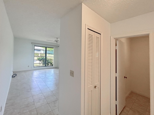 4940 Hawkwood Way Unit A, Boynton Beach, FL 33436 - hallway with light tile patterned floors and a textured ceiling
