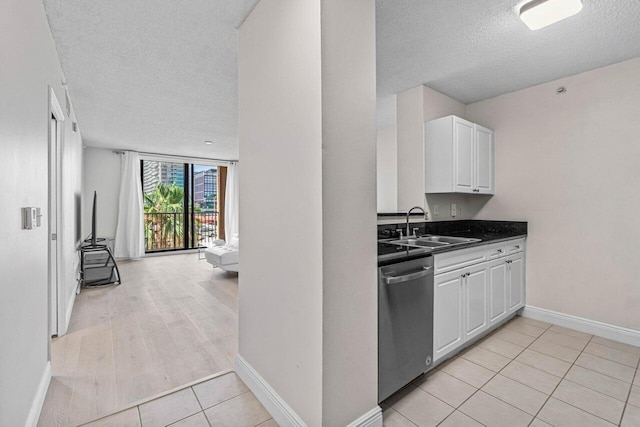 651 Okeechobee Blvd Unit 408, West Palm Beach, FL 33401 - kitchen with dishwasher, a sink, a textured ceiling, white cabinets, and dark countertops