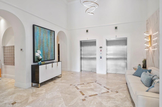 651 Okeechobee Blvd Unit 408, West Palm Beach, FL 33401 - living room with elevator, baseboards, arched walkways, and a towering ceiling