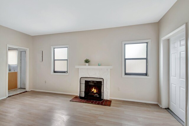 701 S J St, Lake Worth Beach, FL 33460 - unfurnished living room with a fireplace, light wood finished floors, and plenty of natural light