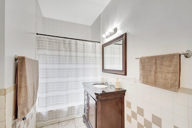 701 S J St, Lake Worth Beach, FL 33460 - bathroom featuring vanity, tile walls, tile patterned floors, curtained shower, and a wainscoted wall