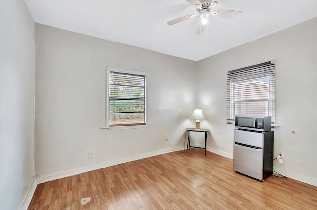 701 S J St, Lake Worth Beach, FL 33460 - unfurnished office with light wood-style floors, a ceiling fan, and baseboards