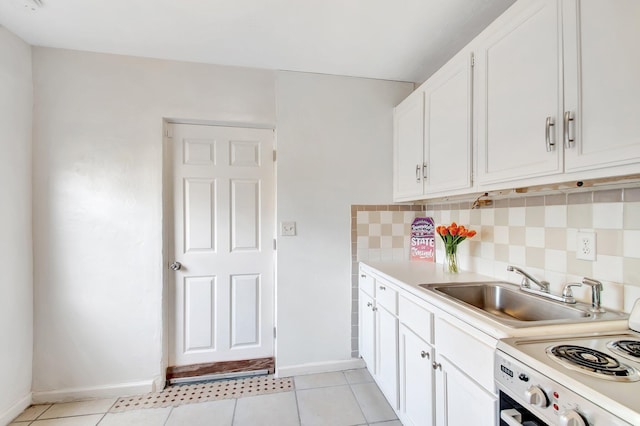 701 S J St, Lake Worth Beach, FL 33460 - kitchen with white electric stove, baseboards, backsplash, a sink, and white cabinets