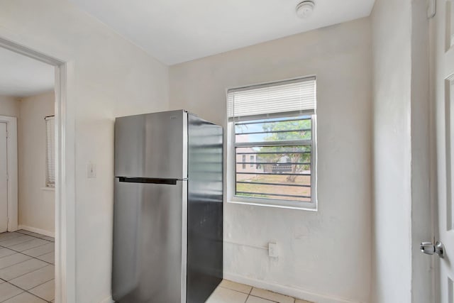 701 S J St, Lake Worth Beach, FL 33460 - kitchen featuring freestanding refrigerator, light tile patterned floors, and baseboards