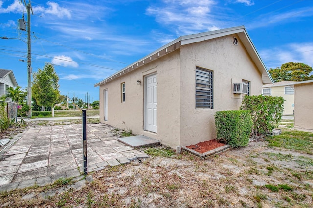 701 S J St, Lake Worth Beach, FL 33460 - back of property featuring stucco siding and a patio