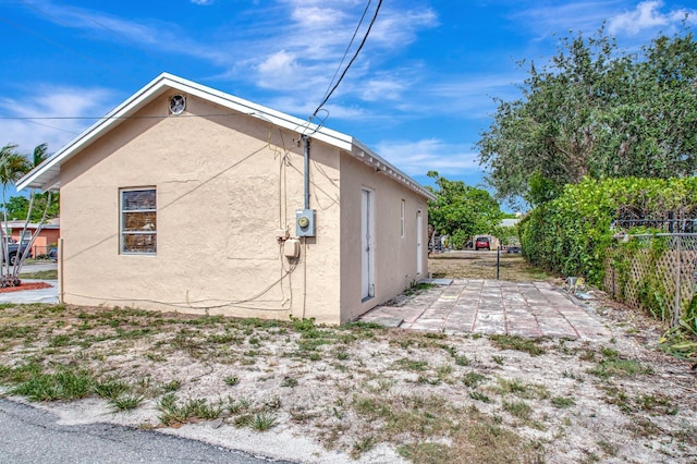 701 S J St, Lake Worth Beach, FL 33460 - view of home's exterior with stucco siding and a patio