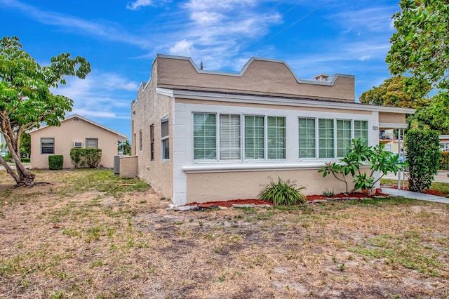 701 S J St, Lake Worth Beach, FL 33460 - view of home's exterior featuring stucco siding and cooling unit