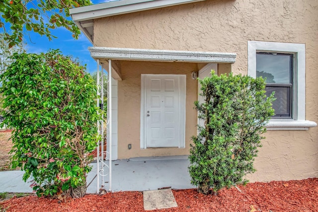 701 S J St, Lake Worth Beach, FL 33460 - doorway to property featuring stucco siding