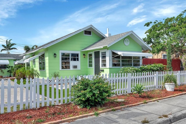713 10th Ave N, Lake Worth Beach, FL 33460 - view of front of property with a shingled roof and a fenced front yard