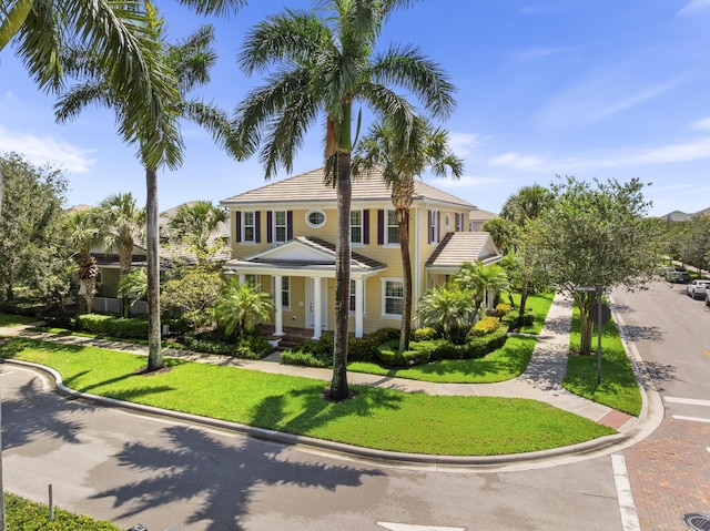 2757 Wymberly Dr, Jupiter, FL 33458 - view of front facade featuring a front yard and covered porch