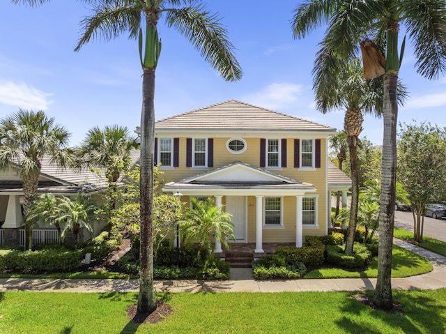 2757 Wymberly Dr, Jupiter, FL 33458 - view of front facade with a porch and a front lawn