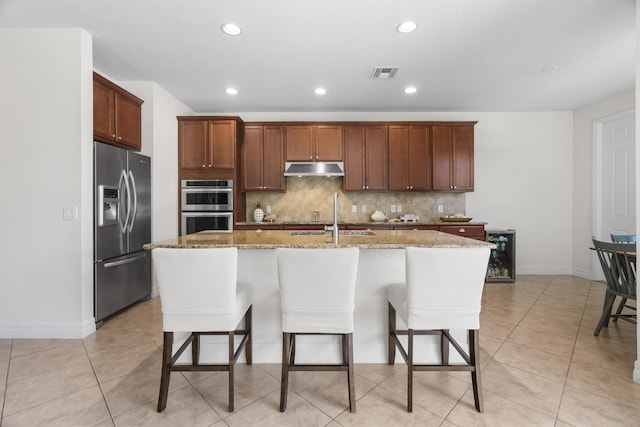 2757 Wymberly Dr, Jupiter, FL 33458 - kitchen featuring stainless steel appliances, beverage cooler, a sink, backsplash, and light stone counters
