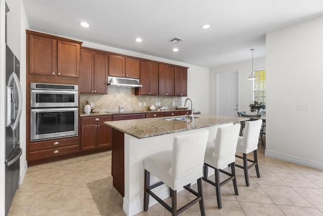 2757 Wymberly Dr, Jupiter, FL 33458 - kitchen with under cabinet range hood, a sink, double oven, black electric stovetop, and tasteful backsplash