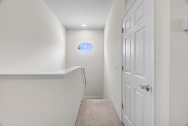 2757 Wymberly Dr, Jupiter, FL 33458 - hall featuring an upstairs landing, a textured ceiling, carpet flooring, and baseboards