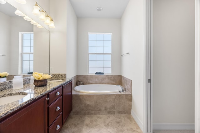 2757 Wymberly Dr, Jupiter, FL 33458 - full bath with double vanity, a garden tub, healthy amount of natural light, and tile patterned floors