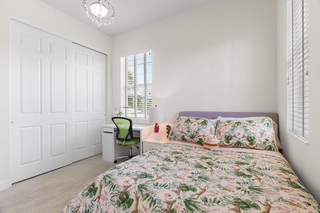 2757 Wymberly Dr, Jupiter, FL 33458 - bedroom featuring light carpet, a closet, and a chandelier