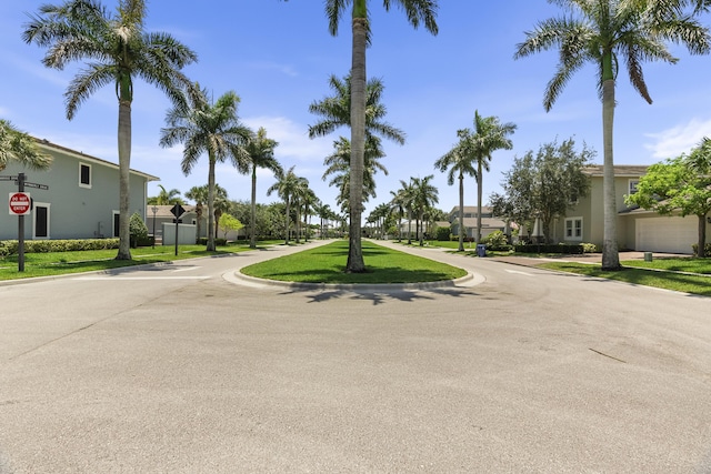 2757 Wymberly Dr, Jupiter, FL 33458 - view of asphalt road with traffic signs, a residential view, and curbs