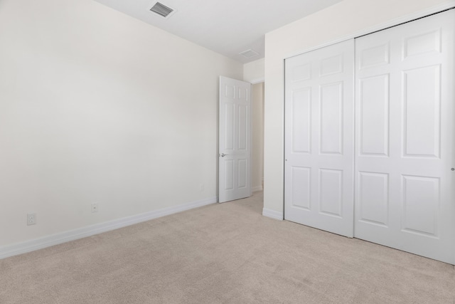 2757 Wymberly Dr, Jupiter, FL 33458 - unfurnished bedroom featuring light carpet, a closet, and baseboards