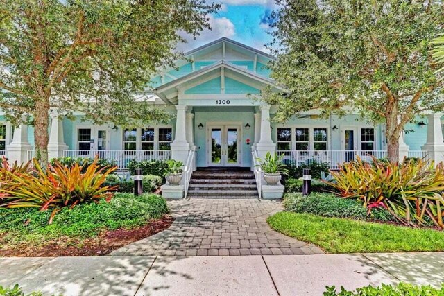 2757 Wymberly Dr, Jupiter, FL 33458 - property entrance featuring french doors and covered porch