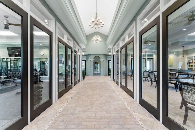 2757 Wymberly Dr, Jupiter, FL 33458 - hall with inlaid floor details, a chandelier, french doors, and ornamental molding