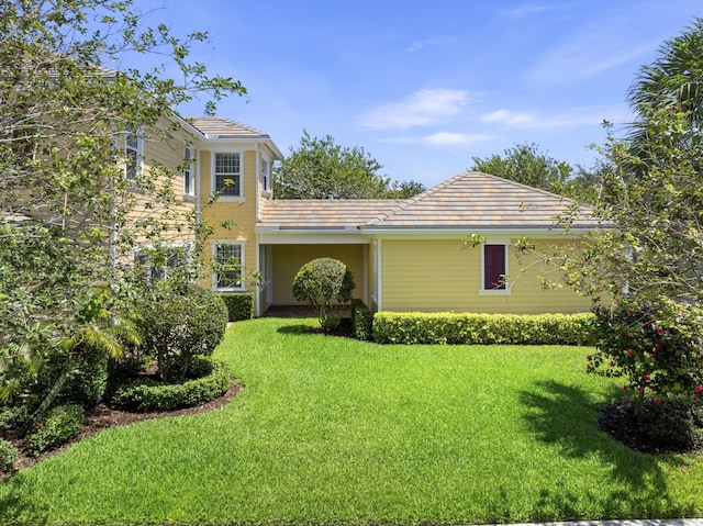 2757 Wymberly Dr, Jupiter, FL 33458 - rear view of property with a yard and a tile roof