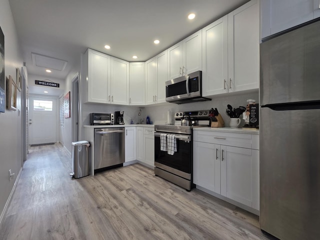 319 N J St, Lake Worth Beach, FL 33460 - kitchen featuring stainless steel appliances, light wood-style floors, white cabinetry, light countertops, and recessed lighting