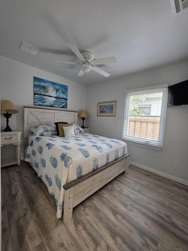 319 N J St, Lake Worth Beach, FL 33460 - bedroom with wood finished floors, baseboards, and a ceiling fan