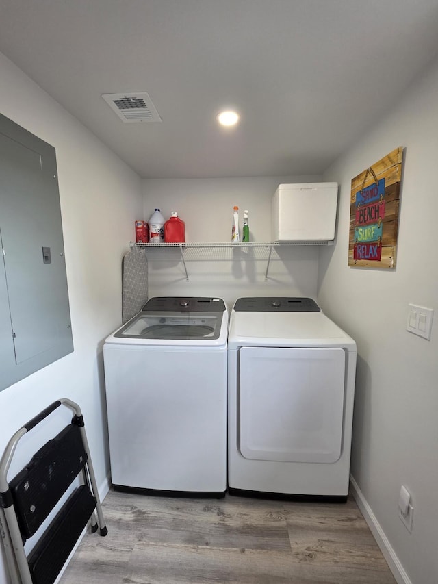 319 N J St, Lake Worth Beach, FL 33460 - laundry room with washer and dryer, electric panel, light wood-style flooring, baseboards, and recessed lighting