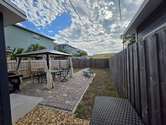 319 N J St, Lake Worth Beach, FL 33460 - fenced backyard with a gazebo, a patio area, outdoor dining area, and grilling area