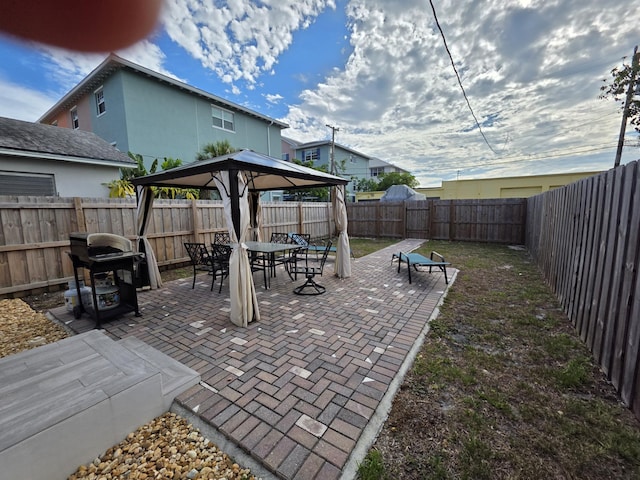 319 N J St, Lake Worth Beach, FL 33460 - fenced backyard with a gazebo, outdoor dining area, and a patio