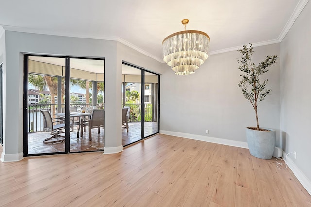 1124 Marine Way W D2R + Boat Slip 19, North Palm Beach, FL 33408 - unfurnished room featuring crown molding, a chandelier, light wood-style floors, and baseboards