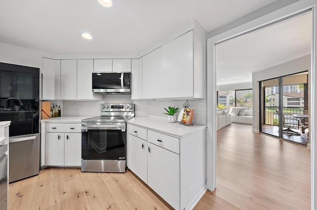 1124 Marine Way W D2R + Boat Slip 19, North Palm Beach, FL 33408 - kitchen with appliances with stainless steel finishes, light countertops, light wood finished floors, white cabinetry, and recessed lighting