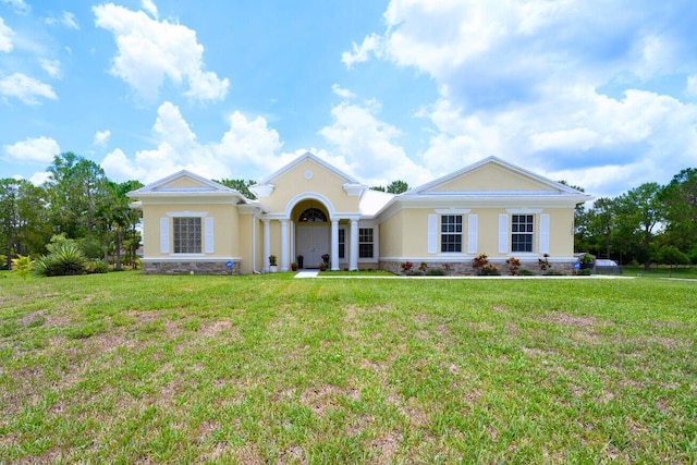 17560 72nd Rd N, The Acreage, FL 33470 - view of front of property featuring stucco siding, a front yard, and stone siding
